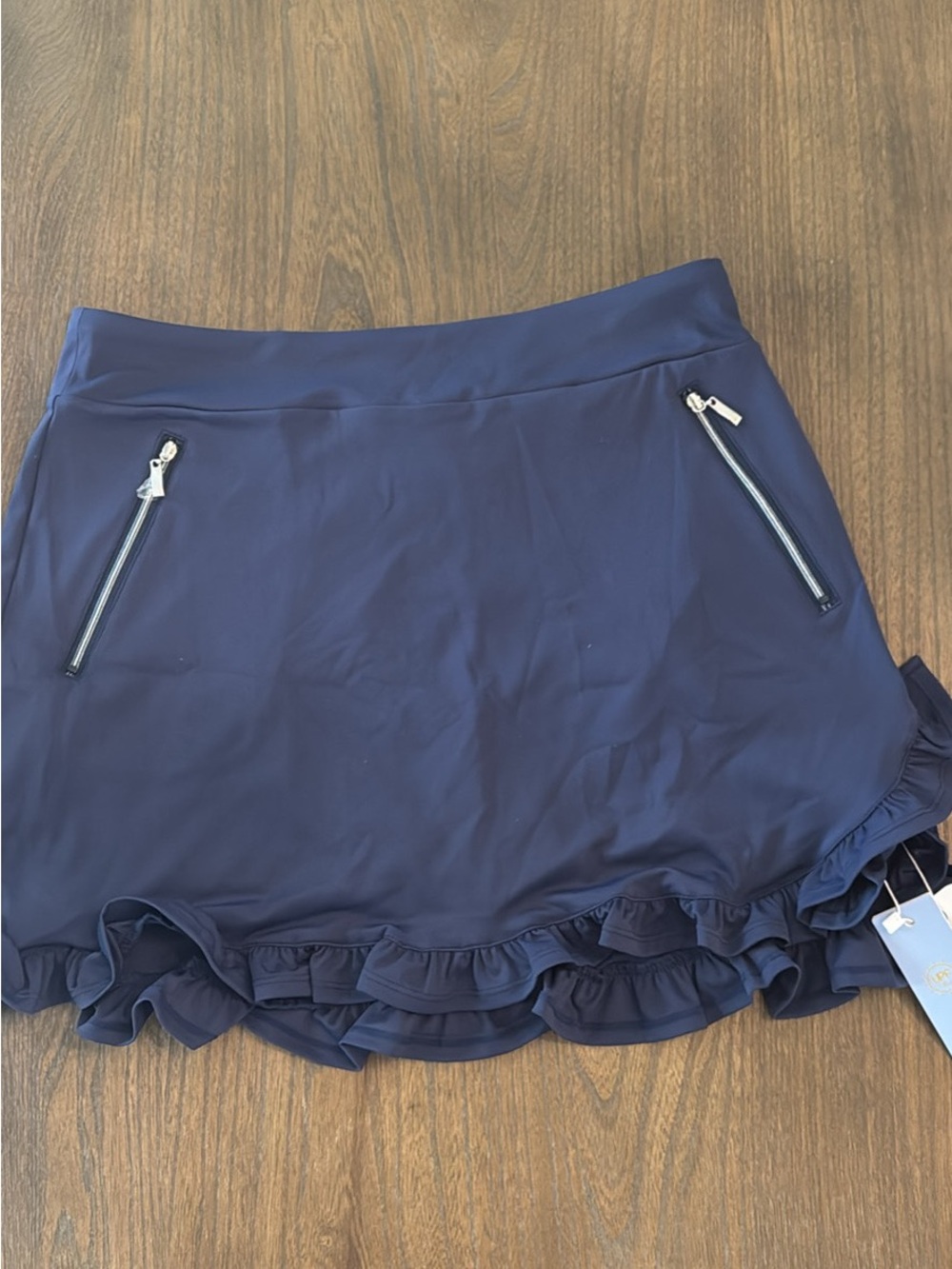 Ace Golf’s Navy Ruffle Hem Active Skort with Zip Pockets